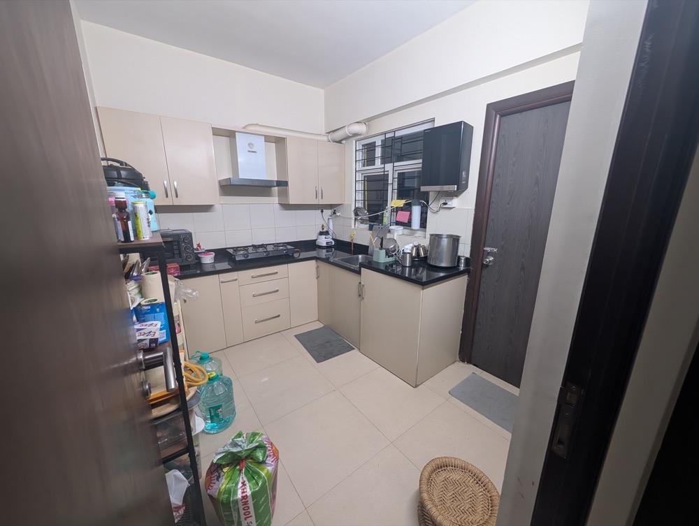 Existing enclosed kitchen with crowded worktops and limited space between cabinets
